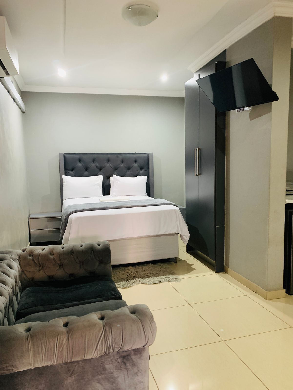 Standard room 1 with queen size bed and modern furnishings at Black Rose Guest House